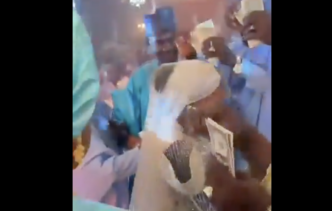 Screenshot of guests spraying the bride